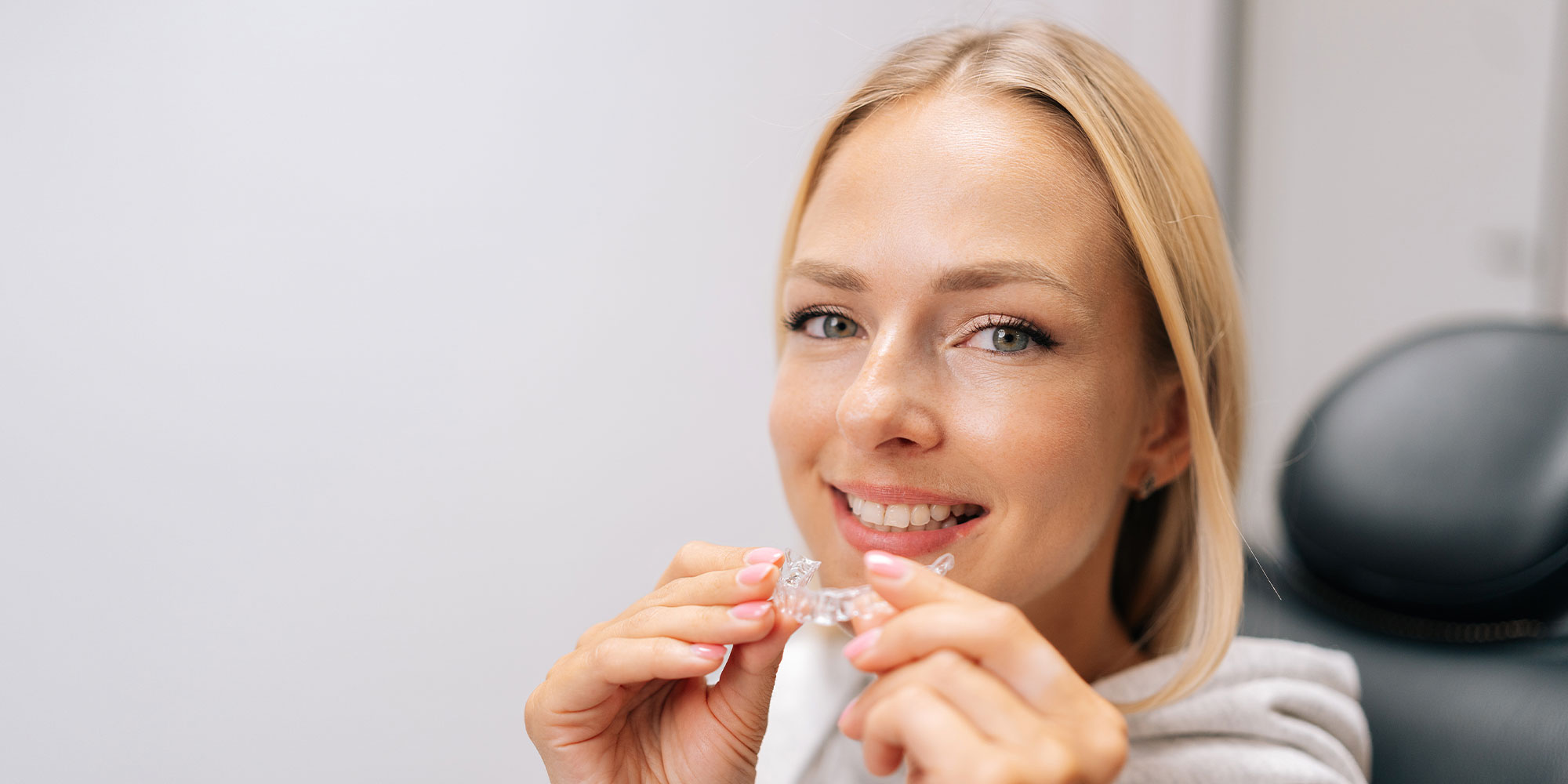 invisalign patient aligner in hand